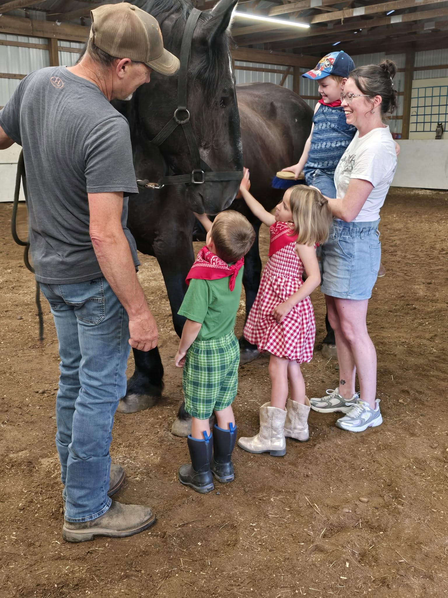 A visitor saying hello to a Journey Equus horse.