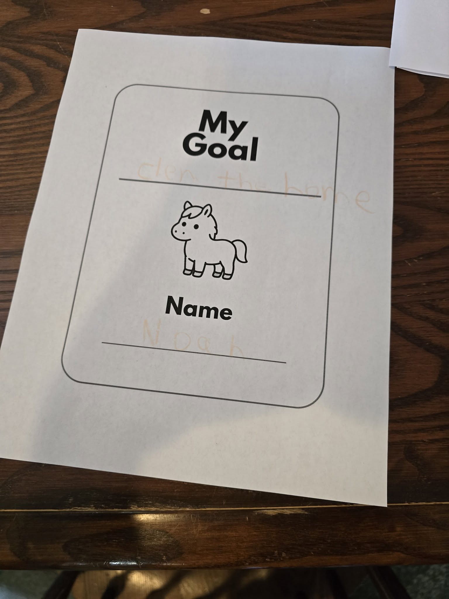 A young learner working in an activity book at the farm.